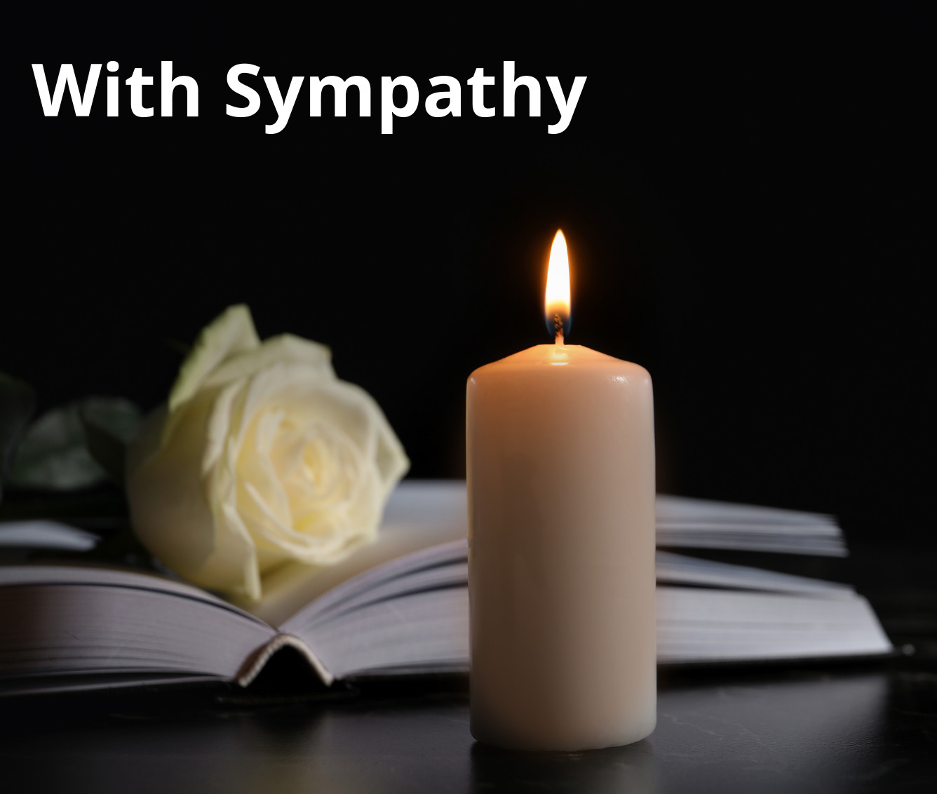 bible with lit candle and white rose. With Sympathy 